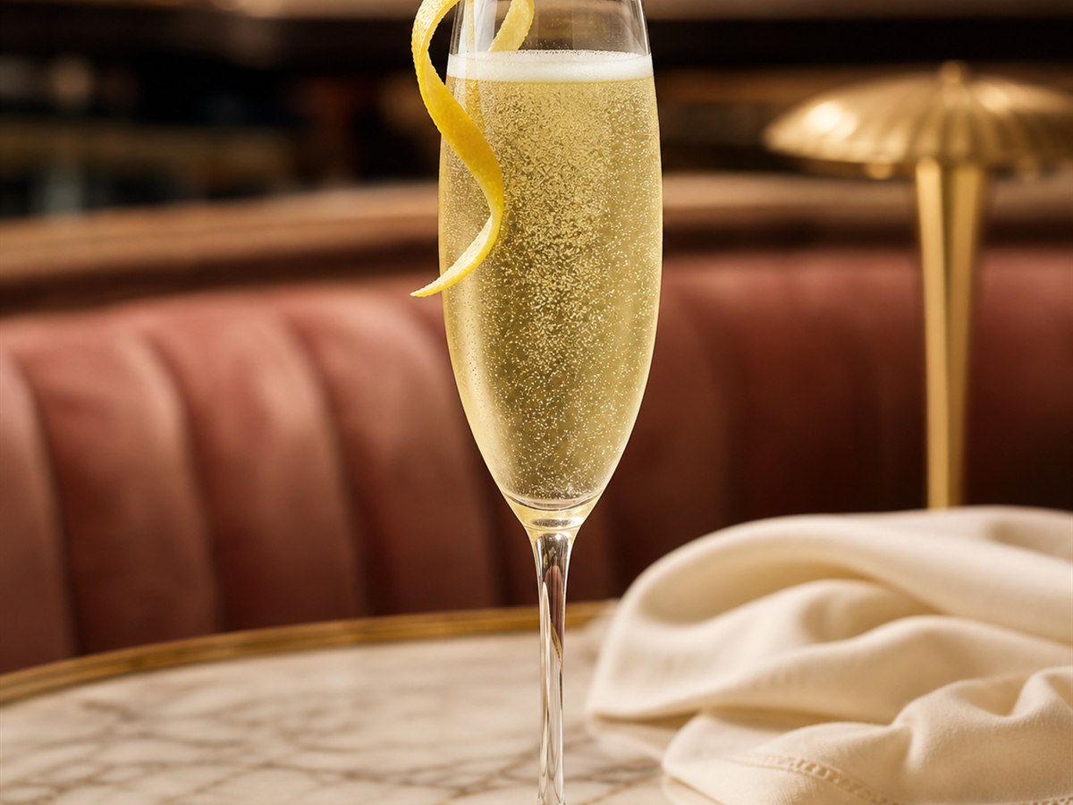 French 75 cocktail served in a champagne flute with lemon twist